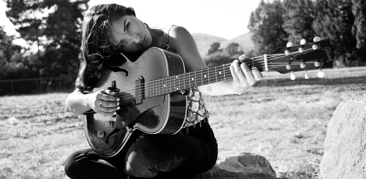 Singer-songwriter Jade Jackson performing with a guitar